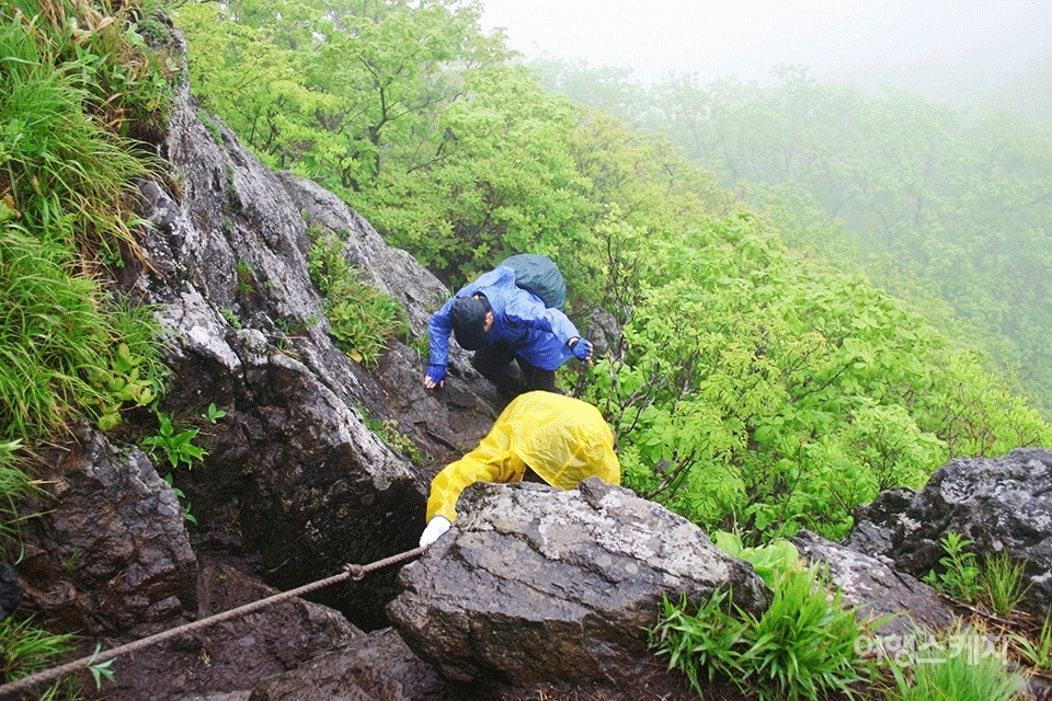 우중산행에서 암릉을 오를 때 미끄러지지 않도록 각별히 주의해야 한다. 2004년 7월. 사진 / 박상대 기자