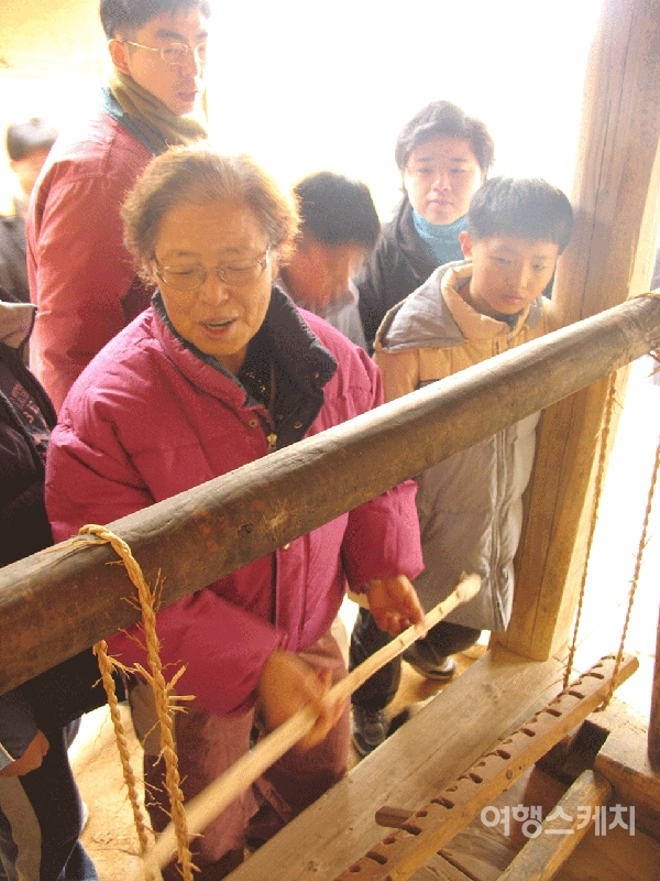 '이하복 전통가옥'에서 오랜만에 마주친 가마니틀을 보고 반가워하는 할머니. 2005년 2월. 사진 / 김진용 기자